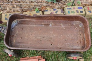 Holes drilled in the bottom. Notice the dent,